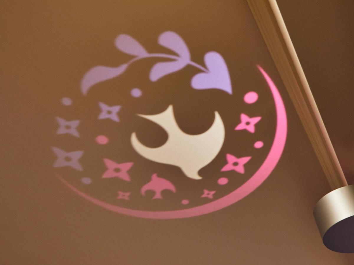 Hotel Grand Nikko Tokyo Bay Maihama Urayasu Exterior foto The image shows a projection on a surface, featuring a circular design with a mix of colors, primarily pink and purple. The design includes a white dove, which is likely a symbol of peace, surrounded by decorative elements such as leaves and small st